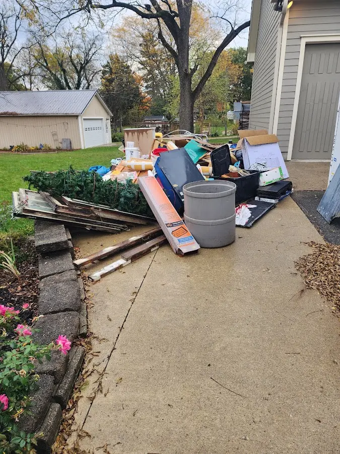 Dumpster being loaded with debris for Demolition Dumpster Rental in Burrell